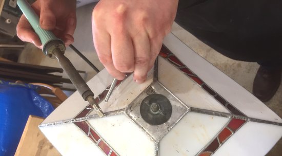 Mike Caddy of Vitreus Art soldering this lamp at the studio