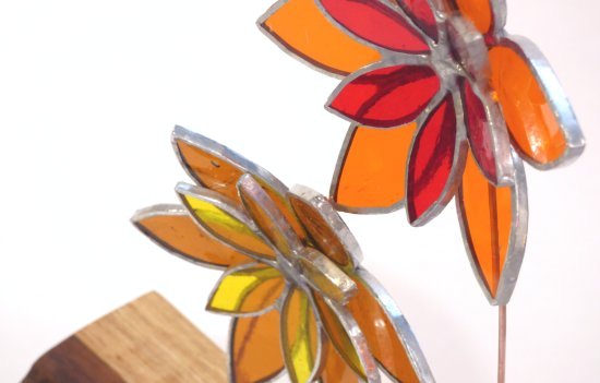 Copper foiled stained glass flowers on a reclaimed wooden base made by Vitreus Art