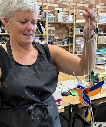 A colourful stained glass hummingbird made on the Vitreus Art workshop